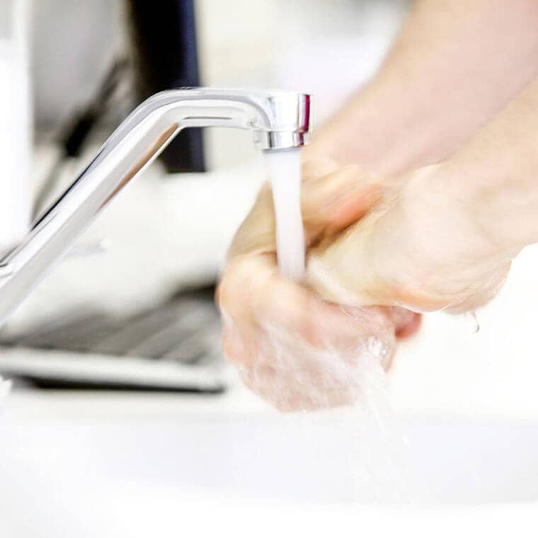 The doctor washes his hands before starting treatment